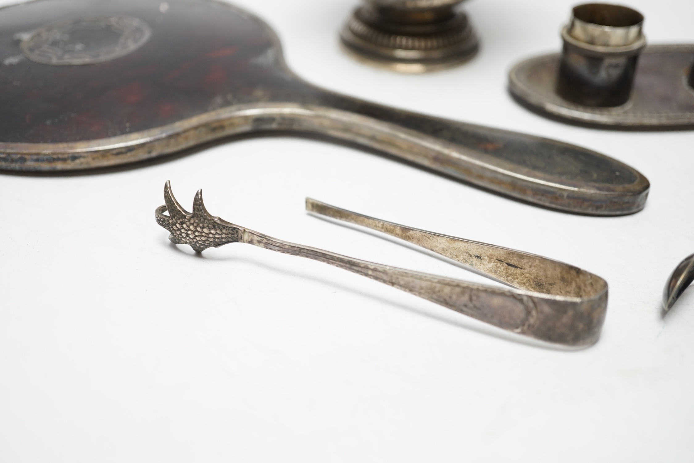 A French white metal small pedestal vase, 10.8cm, a silver and tortoiseshell mounted hand mirror and three other items including a pair of silver sugar tongs.